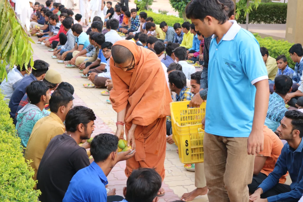 Copy of GuruShree Serving Mangoes